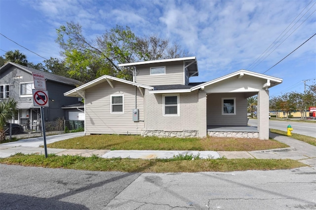 bungalow-style house with brick siding