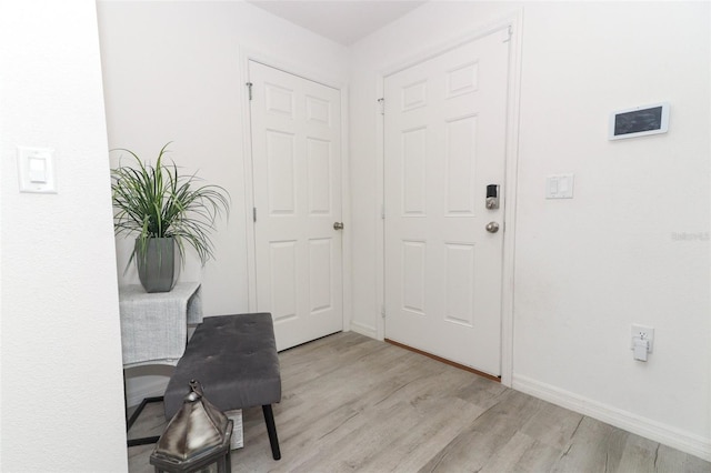 foyer entrance with light hardwood / wood-style flooring