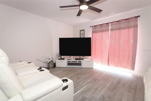 living room with ceiling fan and light wood-type flooring