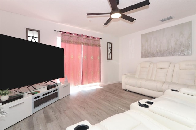 living room with ceiling fan and light wood-type flooring