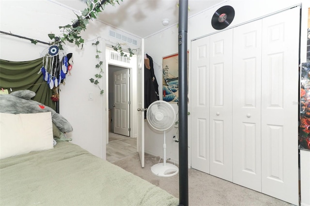 bedroom with light colored carpet and a closet