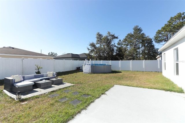 view of yard with an outdoor living space and a fenced in pool