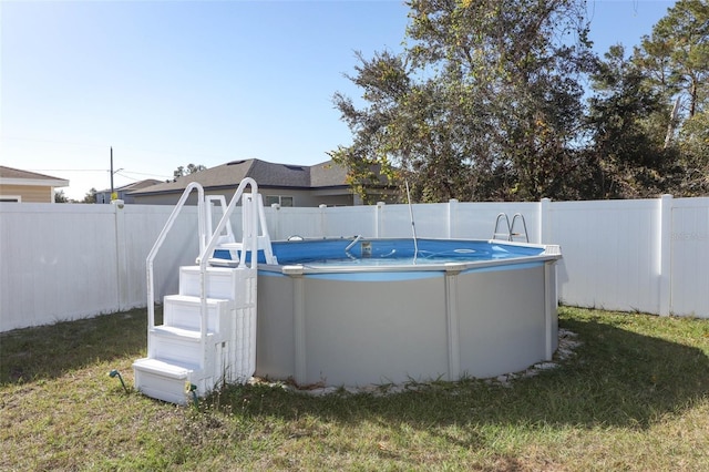 view of pool featuring a yard