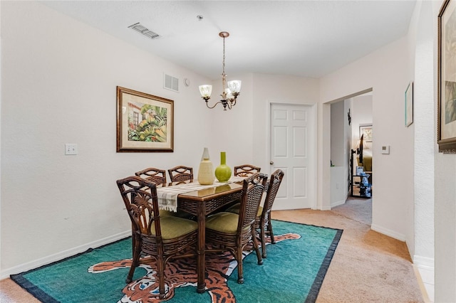 dining space with light carpet and a notable chandelier