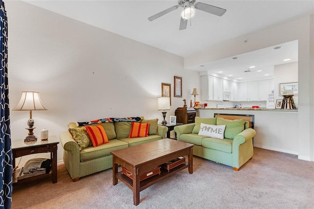 carpeted living room with ceiling fan