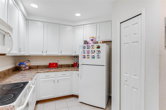 kitchen featuring white cabinetry, white appliances, and light tile patterned floors