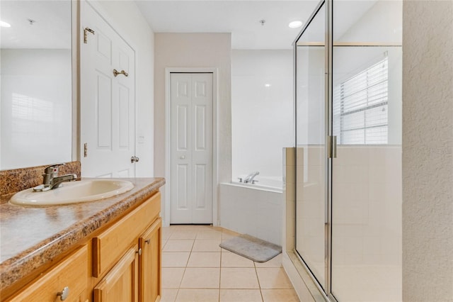 bathroom featuring tile patterned flooring, vanity, and independent shower and bath