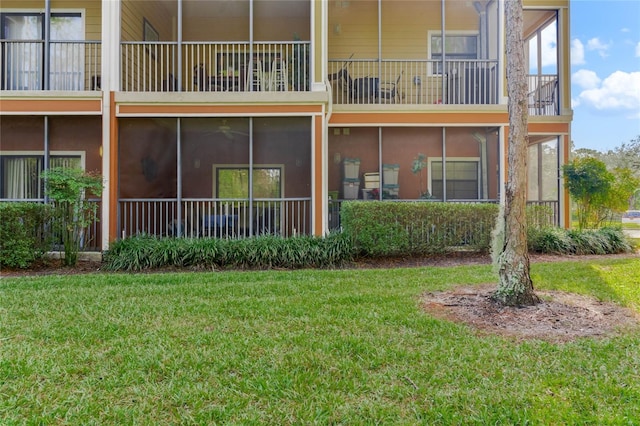 rear view of house featuring a lawn