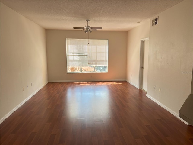 spare room featuring a textured ceiling, ceiling fan, and dark hardwood / wood-style floors