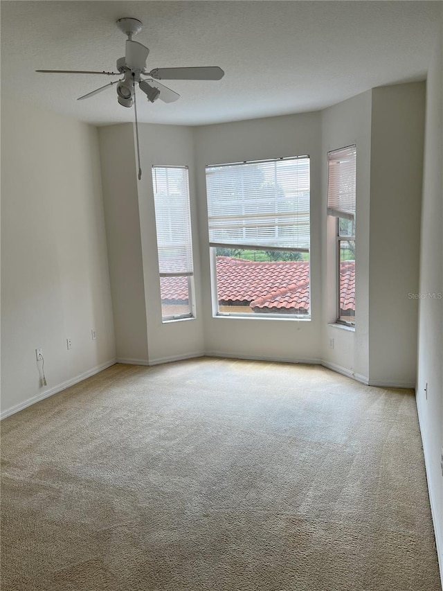 carpeted empty room with ceiling fan