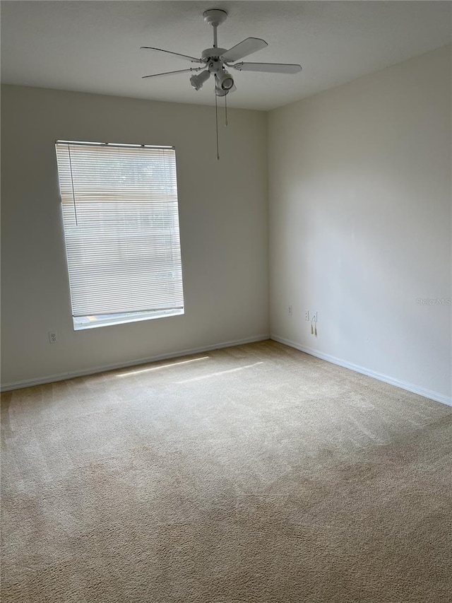 carpeted empty room featuring ceiling fan