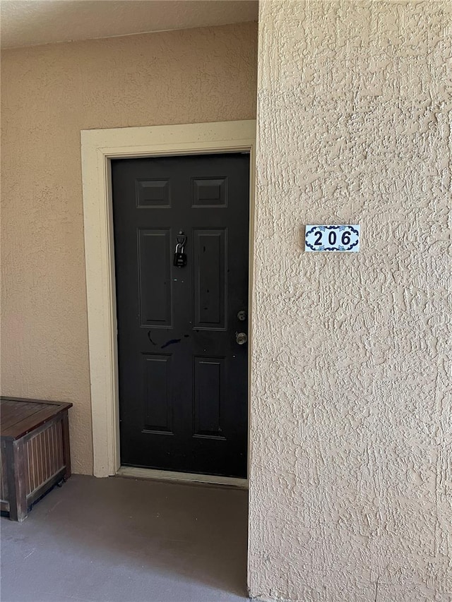 property entrance featuring stucco siding