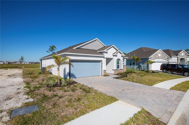 ranch-style house with a garage and a front yard