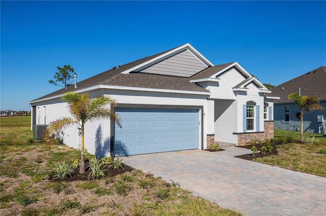 view of front of home featuring cooling unit and a garage