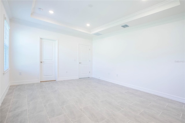 unfurnished room with a tray ceiling and crown molding