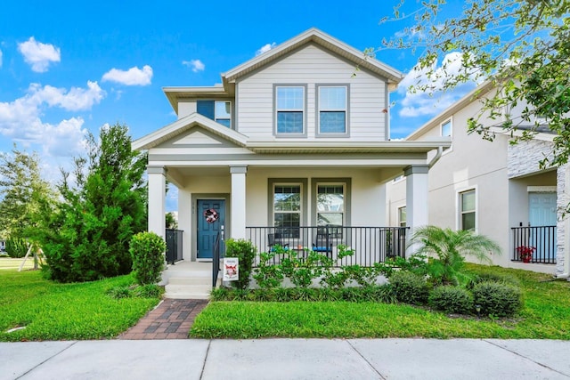 view of front of home with covered porch and a front yard