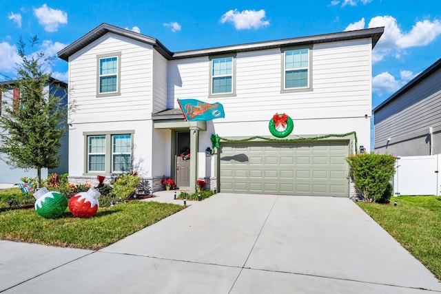 front of property with a garage and a front lawn