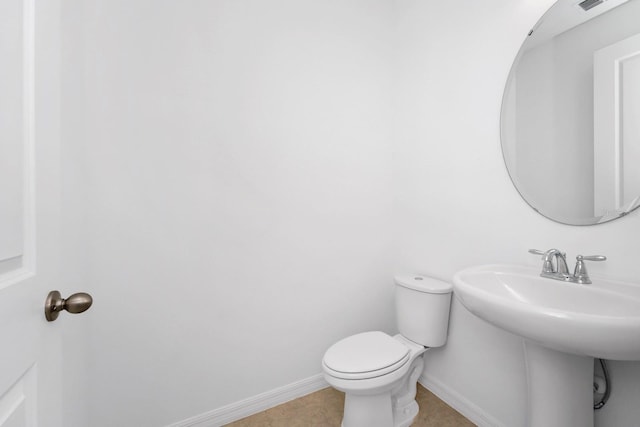 bathroom featuring tile patterned flooring and toilet