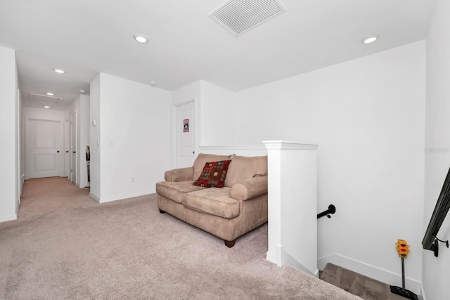 living area featuring light carpet