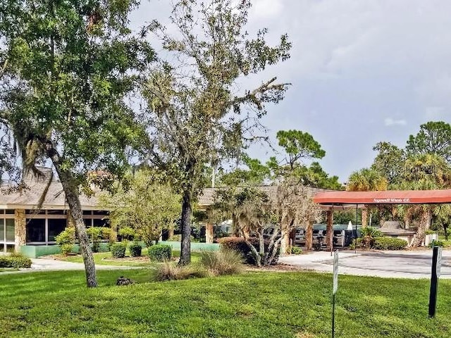 view of property's community with a lawn