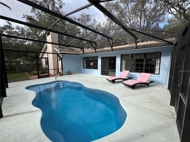 view of swimming pool with a lanai and a patio