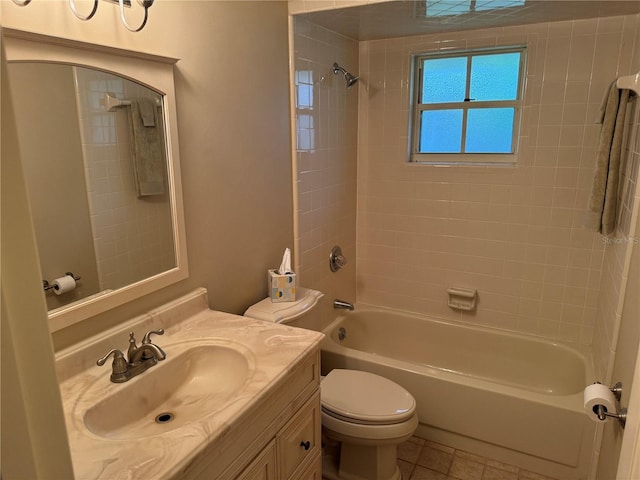 full bathroom with tiled shower / bath, tile patterned flooring, vanity, and toilet