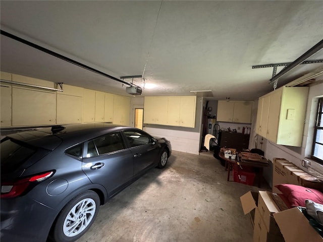 garage featuring radiator heating unit and a garage door opener