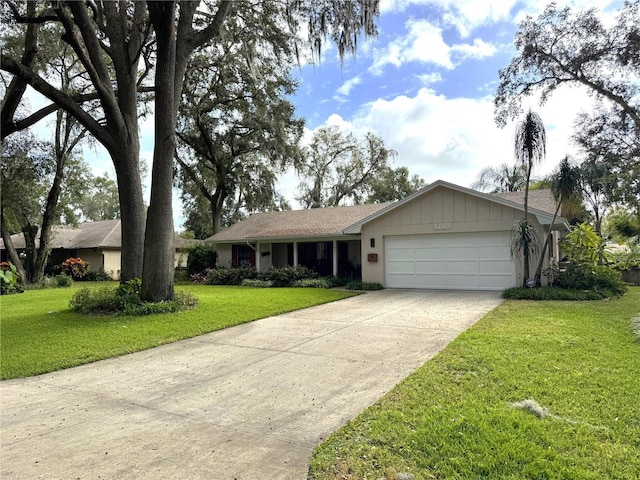 ranch-style home with a garage and a front lawn