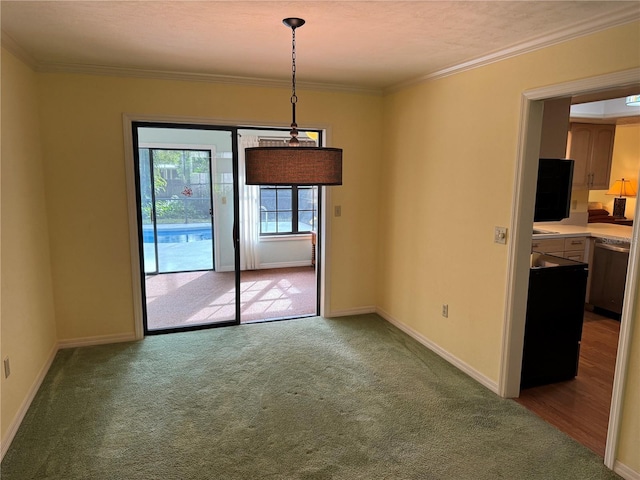 unfurnished dining area with carpet and crown molding