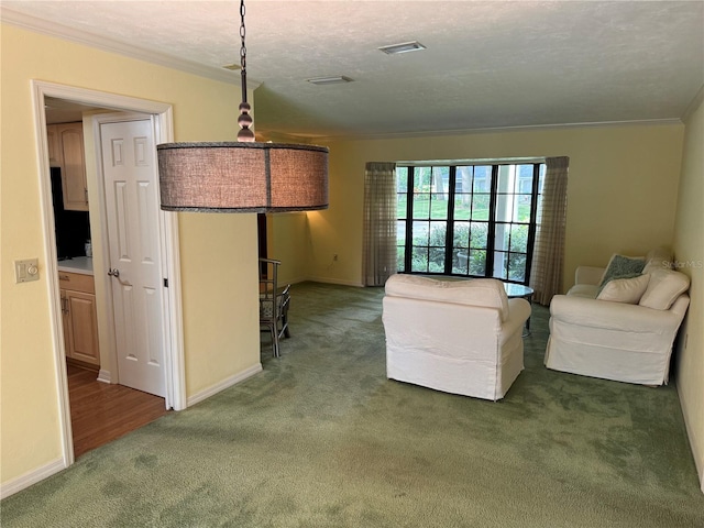 unfurnished living room with a textured ceiling, dark carpet, and crown molding