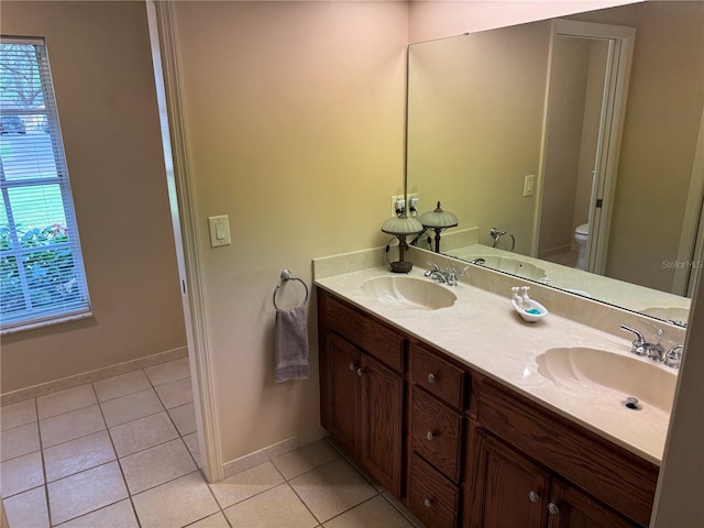 bathroom featuring toilet, vanity, and tile patterned floors