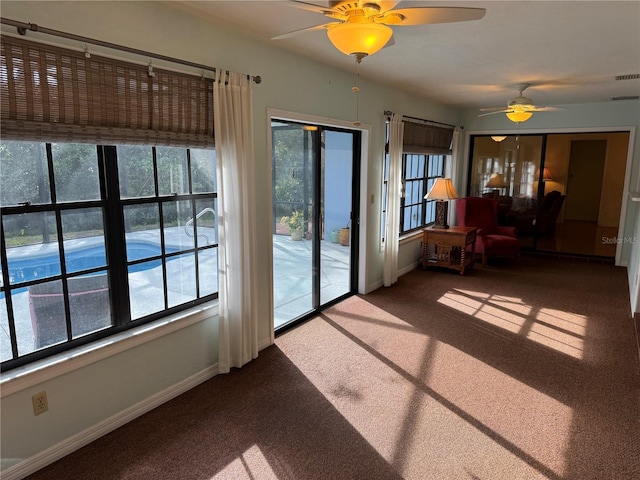 carpeted spare room with ceiling fan