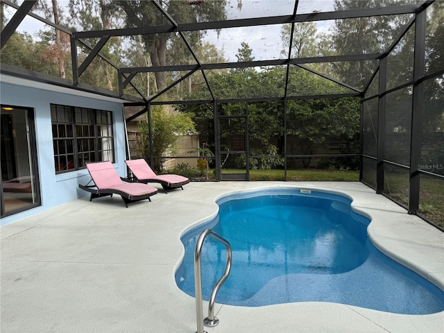 view of swimming pool featuring a lanai