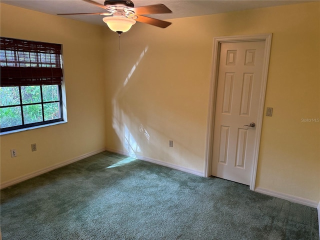 carpeted spare room with ceiling fan