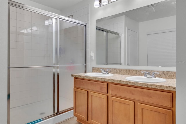 bathroom featuring vanity and a shower with shower door