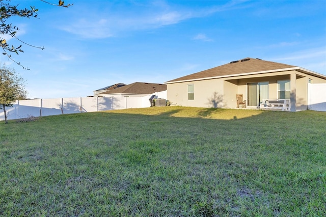 rear view of property with a yard