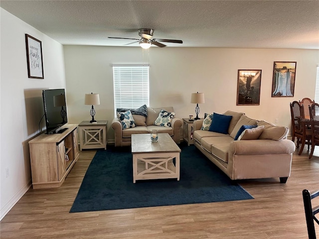 2325 Crossandra St, Mascotte, FL 34753 - living room with a ceiling fan, wood finished floors, and a textured ceiling