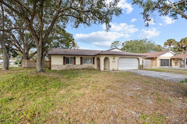 single story home featuring a front yard and a garage