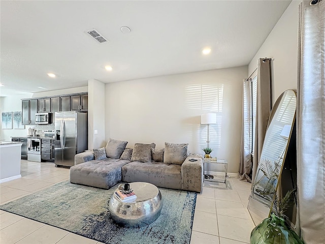 living room featuring light tile patterned flooring and vaulted ceiling