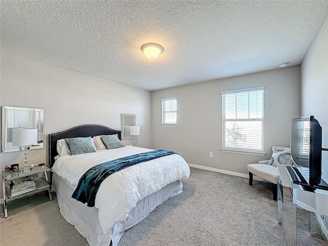 bedroom featuring carpet and a textured ceiling