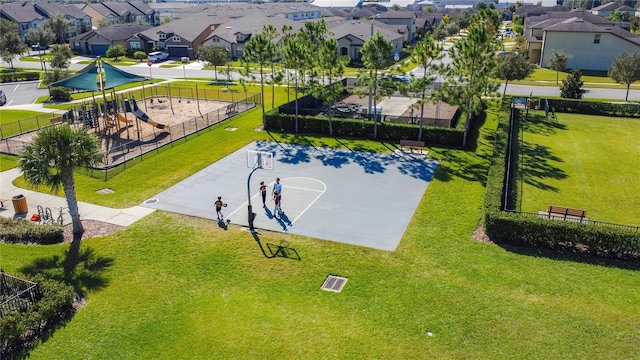 view of sport court with a playground and a lawn