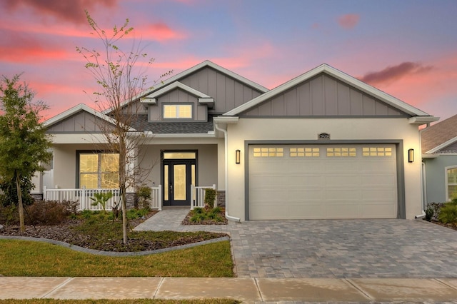 view of front of home featuring a porch and a garage