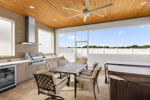 sunroom / solarium featuring wood ceiling, ceiling fan, sink, and beverage cooler