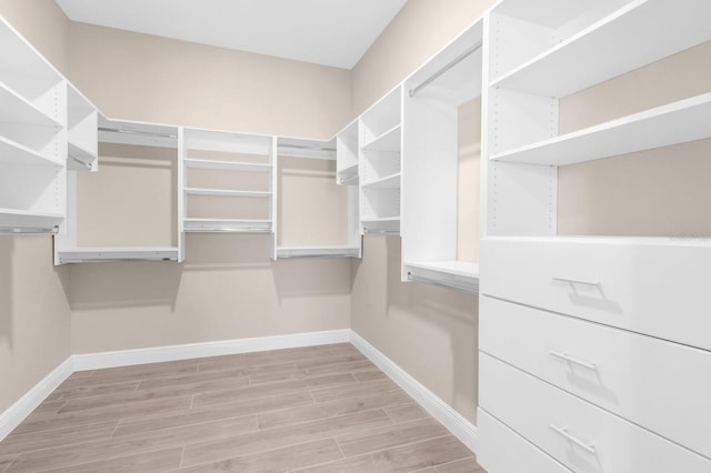 walk in closet featuring light hardwood / wood-style flooring