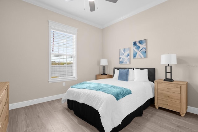 bedroom with ceiling fan, light wood-type flooring, and ornamental molding