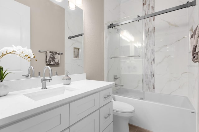 full bathroom featuring vanity, tiled shower / bath combo, and toilet