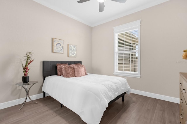 bedroom featuring light hardwood / wood-style floors, ceiling fan, and ornamental molding