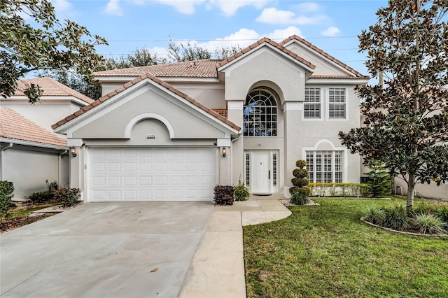 mediterranean / spanish home with a garage and a front lawn