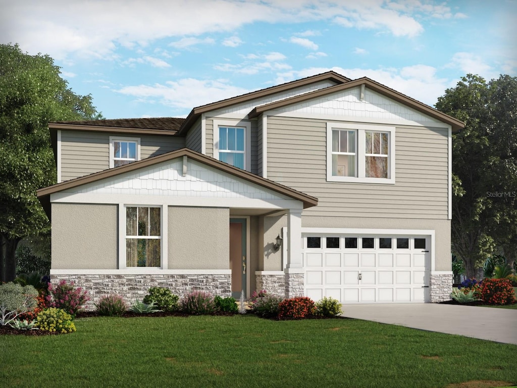 view of front facade with a front yard and a garage