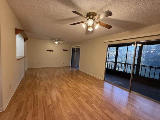 unfurnished room with a textured ceiling, light hardwood / wood-style floors, and ceiling fan